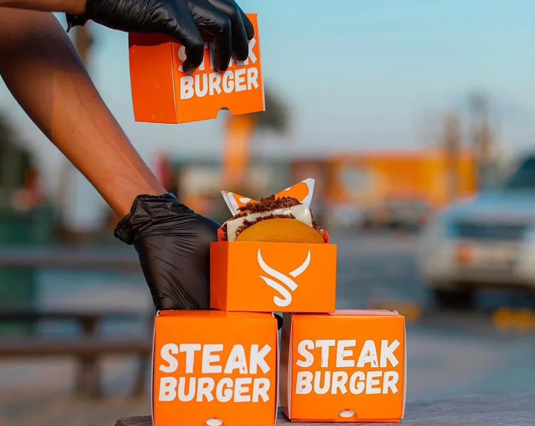 Steaks & Butter boxes being stacked on a table at one of its outlets